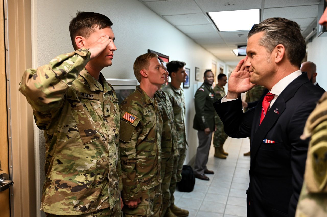 U.S. Secretary of Defense Pete Hegseth returns a U.S. Army Soldier’s salute during a coining ceremony at Joint Base Elmendorf-Richardson, Alaska, Aug. 15, 2025 during an international summit between U.S. President Donald J. Trump and Russian President Vladimir Putin.